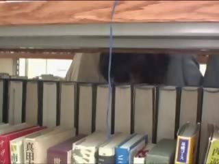 Young young female elläp tanamak in library